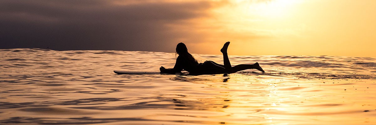 woman surfing in sunset orgasmic